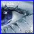 Pixelated static image of a dark blue cartoon character with large white eyes and black pupils, partially visible against a light gray background with subtle darker shapes.