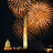 A pixelated static image shows a tall, light-colored monument with fireworks bursting above it against a dark background.