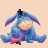 A pixelated blue donkey with a pink bow tie sits in a cross-legged pose against a light beige background, with text above and below the figure.