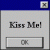 Static pixel art displays 'Kiss Me!' text on a light gray background with blue top border and dark gray bottom frame.