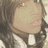 Pixelated close-up of a person's face with dark hair, light skin tone, and white clothing visible at the bottom edge.