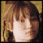 A pixelated image of a person with brown hair and bangs, with text reading "Violet Baudelaire" on a black background.
