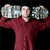 A person in a maroon long-sleeve shirt holds two large silver dumbbells above shoulder height against a black background.