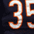 Pixelated football player wearing dark blue jersey with orange and white number 35, smiling face visible in multiple