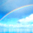 A static pixelated image of a rainbow arching across a blue sky with white clouds, rendered in low-resolution digital style.
