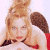 A pixelated image of a person with light brown hair in a red top against white and dark background, next to green text reading Original Icons .com.