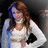 A woman with long brown hair in a white top and light blue cardigan poses with hands on hips against dark background.