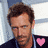 A pixelated image of a person with short brown hair wearing a dark jacket over a light shirt, featuring a pink heart symbol on the chest.