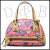 A pink and purple floral-patterned handbag with gold accents, featuring a curved handle and visible text elements in the background.