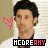 A pixelated image of a person with dark hair wearing a white shirt, featuring pink heart symbols and text reading "MCDREAMY" in black-and-white lettering.