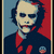 Pixelated portrait of a person with light skin, dark hair, and a red cravat against blue and red background.