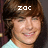 Pixelated close-up of a person with brown hair wearing light blue clothing, overlaid with white pixel-art text 'ZOC' on the forehead.