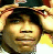 Pixelated static image of a person with dark hair and light skin wearing a yellow top, set against a blurred background with warm tones.