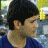A pixelated image of a person with dark hair in profile, wearing a blue shirt against a blurred background, next to green text reading 'OriginalIcons.com' on a solid green backdrop.