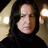 A pixelated image of a person with long dark hair and a black turtleneck, next to a red background with pixelated text reading "Severus Snape Potions Master".