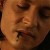 A pixelated close-up of a person's face showing eyes, nose, and mouth with warm brown and orange tones.