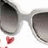 Pixelated image of white sunglasses with dark lenses, a small red heart symbol below left lens, and multiple text blocks in pixel font.