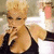A pixelated image of a woman with blonde hair in a black top, holding her hand near her face, with pink text reading "I dont Believe You" overlaid.