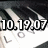 Pixelated static image with large white numerals '10,19,07' on a dark background featuring abstract light and shadow patterns.