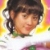 Pixelated close-up of a person with dark hair and a white top against a colorful gradient background.