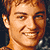 Pixelated of repeated male faces with varying expressions, overlaid text fragments, and cyan block artifacts