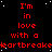 Red text on black background with white dots, repeating 'I'm in love with a heartbreaker' across multiple
