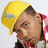 Pixelated image of a person with short brown hair wearing a yellow cap and red-and-white checkered shirt, head tilted back with eyes closed.