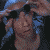 A pixelated animated sequence shows a figure with blue hair and dark goggles adjusting them, followed by a dark aircraft with glowing lights performing maneuvers against a black background.