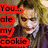 A pixelated image of a character with white face paint and red lips, wearing a dark purple suit and light blue shirt, with text overlays in red boxes.