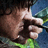 Pixelated image showing a hand holding a gun with red text 'RAMBO' and white date '01.25.08' over blurred background.