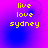 Yellow pixelated text 'live love sydney' on a purple-to-blue gradient background with faint circular patterns.