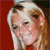 Static pixelated image of a person with light-colored hair against a red background, rendered in low resolution with visible dithering and color blending.