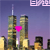Pixelated cityscape with two tall towers under a purple gradient sky, featuring a bright pink heart symbol between them.