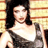 Static 48x48 pixel icon showing a woman with dark shoulder-length hair wearing a white and gray sleeveless dress against a striped background.