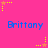A static image with a bright pink background featuring repeated blue text "Brittany" and scattered yellow and orange star-shaped pixel art elements.