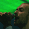 six shows a person singing into a microphone under green lighting, with a green banner displaying 'Coldplay' at the bottom left
