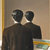 Two dark silhouetted figures in black attire stand side-by-side against a muted brown background with a vertical yellow stripe on the left.