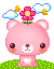 Pink pixelated bear with flower on head, standing on green grass under clouds and bees.