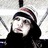 A pixelated image of a person wearing a striped beanie and dark clothing, with cyan text reading "I Cant Get My Mind Off Of Him" on a black background.