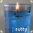 Blue candle in glass container with flickering flame and 'pretty' text below, displayed in