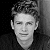 Black-and-white pixelated portrait of a person with short hair against dark background, adjacent to green screen text reading Original Icons .com in bright green font.