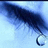 A pixelated blue and white image shows a dark curved shape with a circular end against a light blue background.