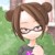 Pixelated cartoon-style icon of a person with brown hair in twin buns, wearing glasses and a dark top with purple accents against green background.