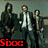 Three men in dark suits stand side-by-side against a muted background, with red text labels changing between frames.