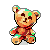 Pixel art teddy bear with brown and orange fur, green accents on ears and limbs, red scarf, and dark brown eyes and nose.