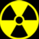 Yellow radiation symbol on black background with scattered yellow and gray pixel clusters across the image.