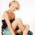 Pixelated image of a person in a bikini holding a baby, with a light background and visible pixelation artifacts.