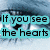 A close-up of a blue-eyed person's face with text overlays and a heart-shaped pupil in the lower-right