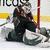 Pixelated hockey goalie in dark uniform crouched on ice with red goalpost visible, next to blue reading LIVE THE DREAM
