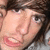 A person with brown hair and light skin appears in a of four showing slight variations in facial expression